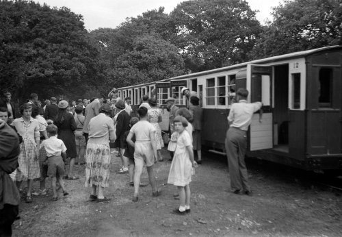 Passengers alight from the opening train at Boston Lodge