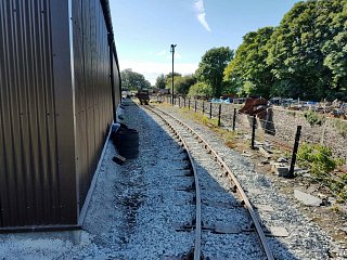 One road leads around the shed, running alongside the coal hole, seen on the right
